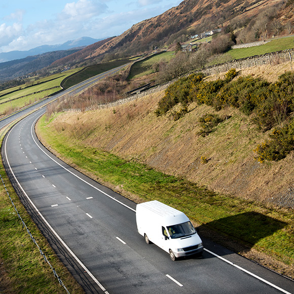 Van driving down picturesque road to depict fleet insurance by Find Insurance NI